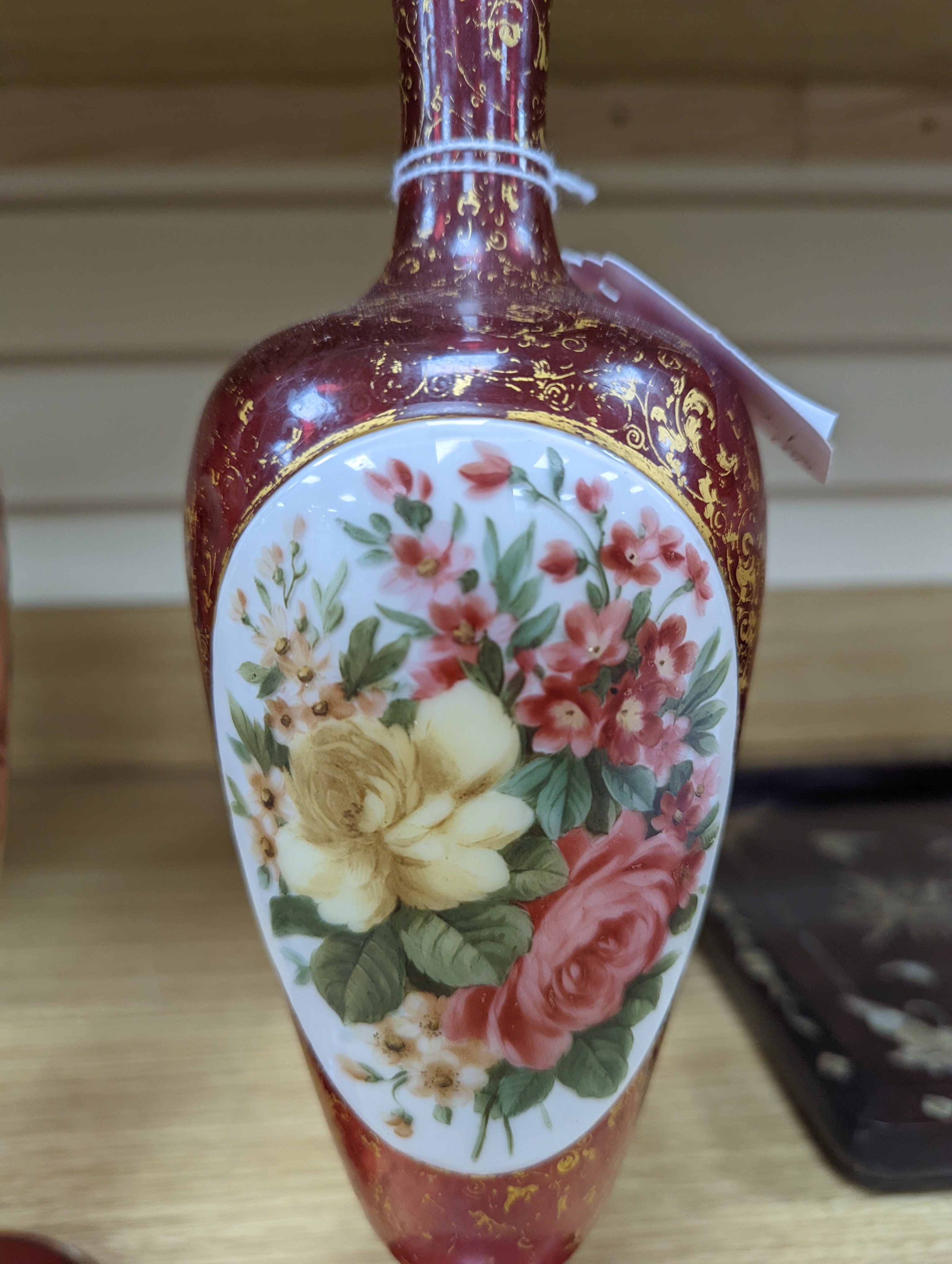 A pair of 19th century Bohemian enamelled and overlaid ruby glass vases 36cm
